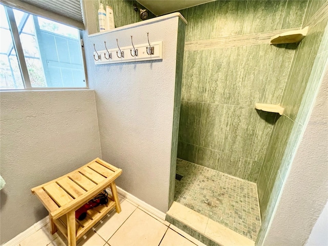 bathroom with tile patterned flooring and tiled shower