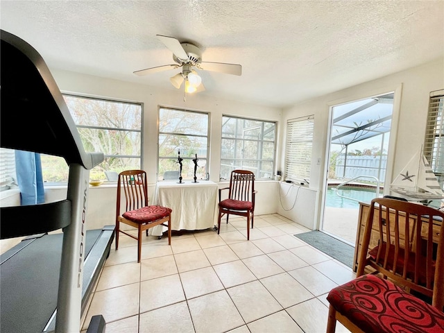 sunroom / solarium featuring ceiling fan and a healthy amount of sunlight