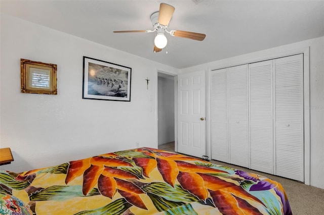 carpeted bedroom with ceiling fan and a closet