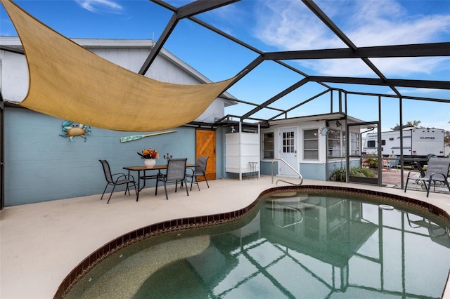 view of pool featuring a patio and glass enclosure