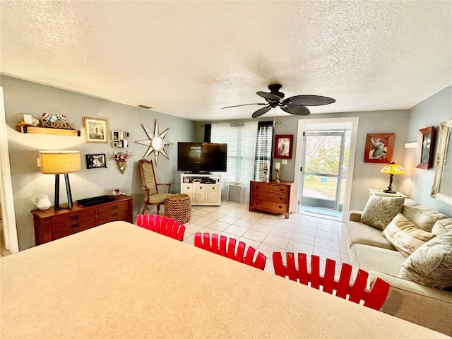 tiled living room featuring a textured ceiling and ceiling fan