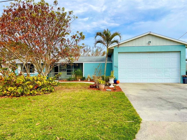 ranch-style house featuring a garage and a front lawn