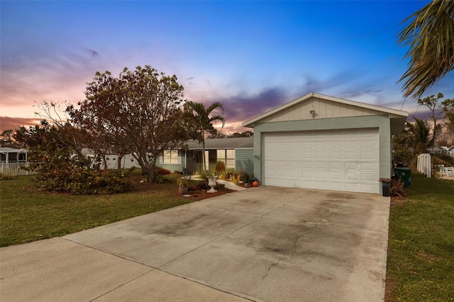 view of front of house with a garage and a yard