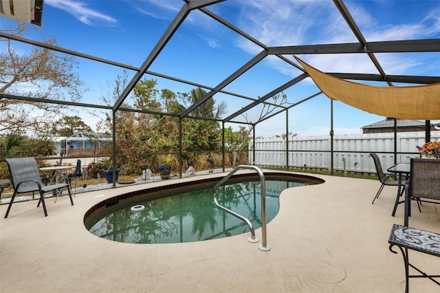 view of swimming pool featuring a lanai and a patio