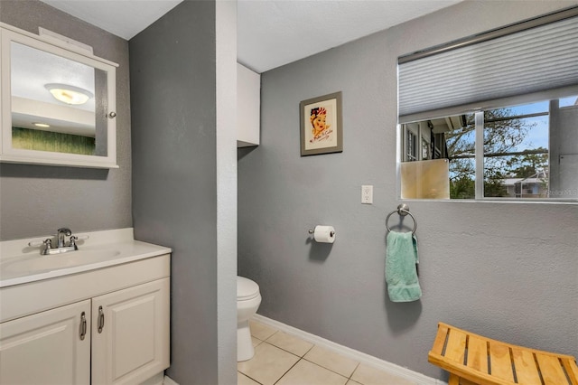 bathroom featuring toilet, vanity, and tile patterned floors