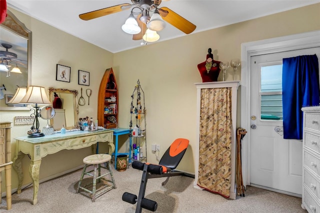 exercise area featuring carpet flooring and ceiling fan