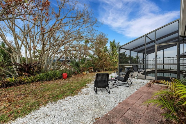 view of patio / terrace featuring glass enclosure