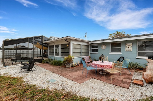 back of property featuring a sunroom and a patio area