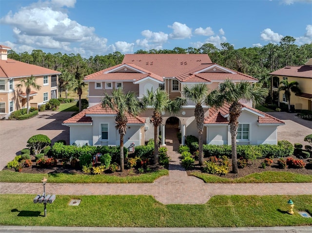 mediterranean / spanish-style home featuring a front lawn