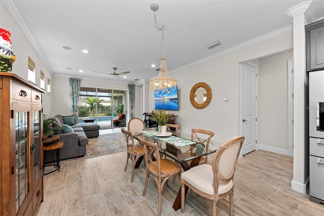 dining room with light hardwood / wood-style floors, ornamental molding, and ceiling fan with notable chandelier