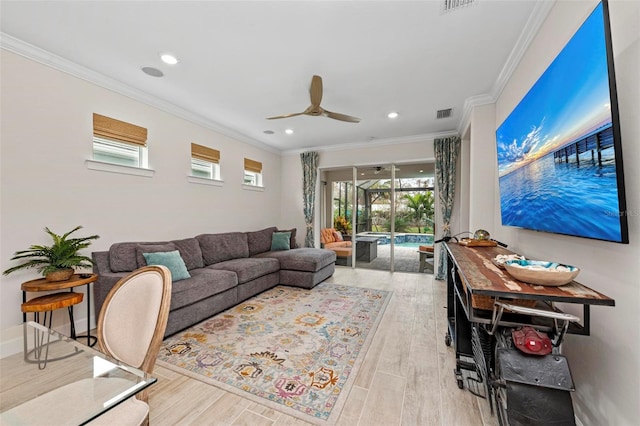 living room featuring light hardwood / wood-style floors, ornamental molding, and ceiling fan