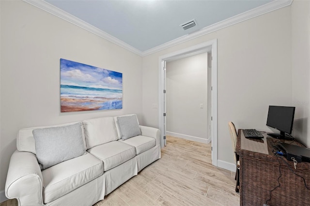 living room with ornamental molding and light hardwood / wood-style floors