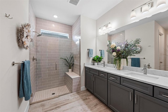 bathroom featuring vanity, an enclosed shower, and hardwood / wood-style flooring