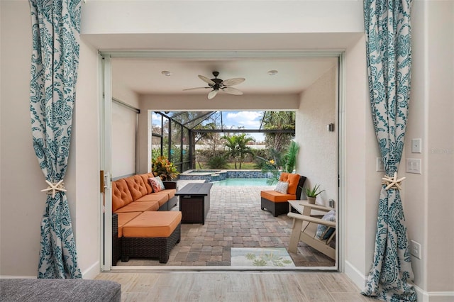 view of patio featuring ceiling fan and a lanai