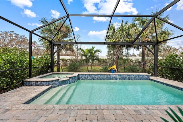 view of pool featuring an in ground hot tub, pool water feature, and glass enclosure