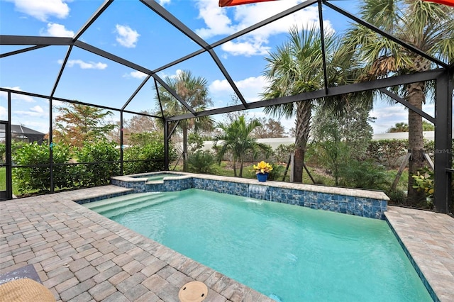 view of swimming pool with a patio area, a lanai, an in ground hot tub, and pool water feature