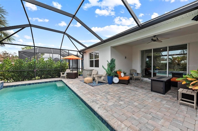 view of pool featuring a patio, an outdoor living space, a lanai, and ceiling fan