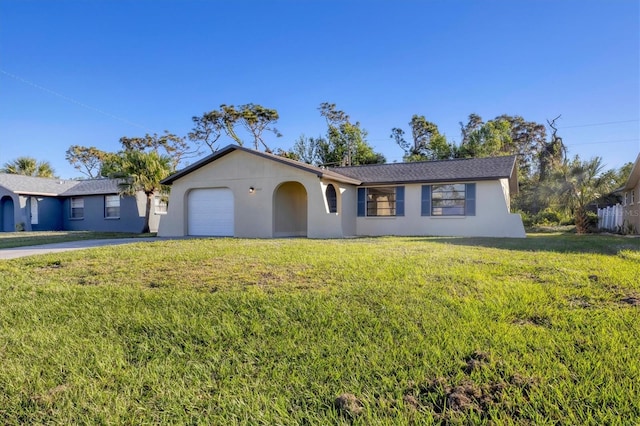 single story home featuring a garage and a front yard