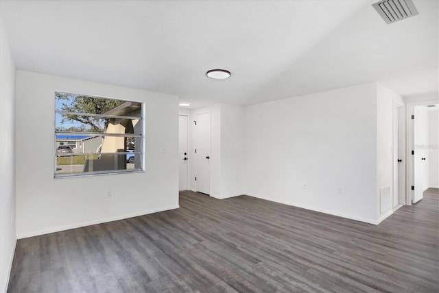 empty room with dark wood-type flooring