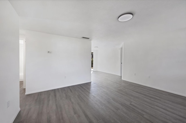 unfurnished room with dark hardwood / wood-style floors