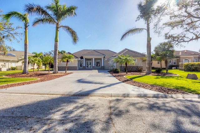 mediterranean / spanish-style home with a front yard