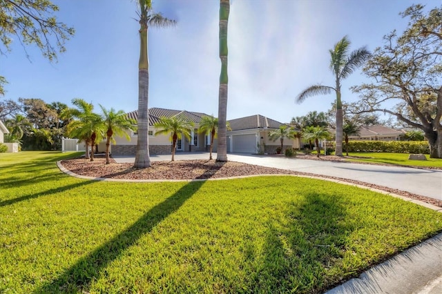 view of front of home with a front yard and a garage