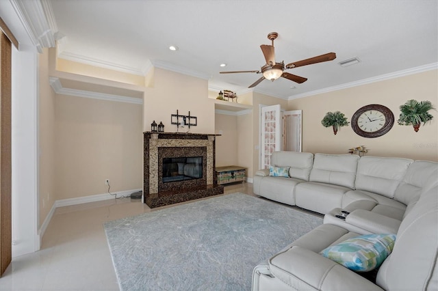 living room featuring ornamental molding, a premium fireplace, and ceiling fan