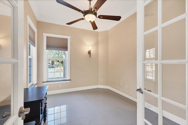 empty room featuring crown molding, french doors, and ceiling fan