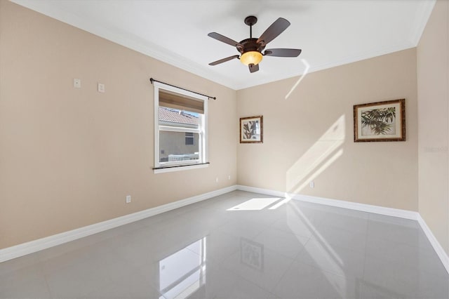 empty room with tile patterned floors, ornamental molding, and ceiling fan