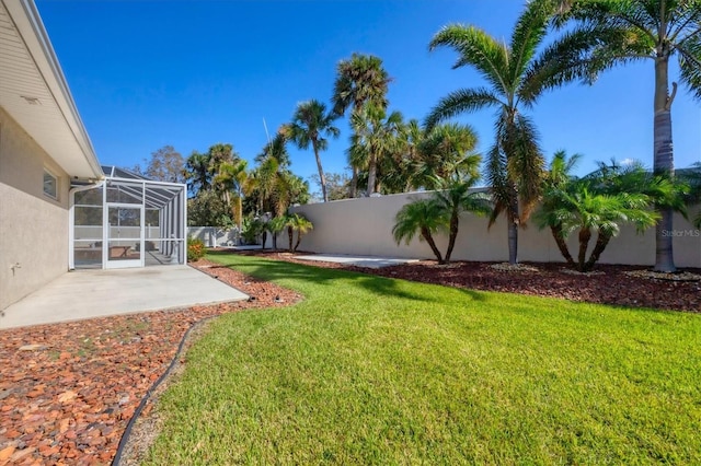 view of yard featuring a patio and a lanai