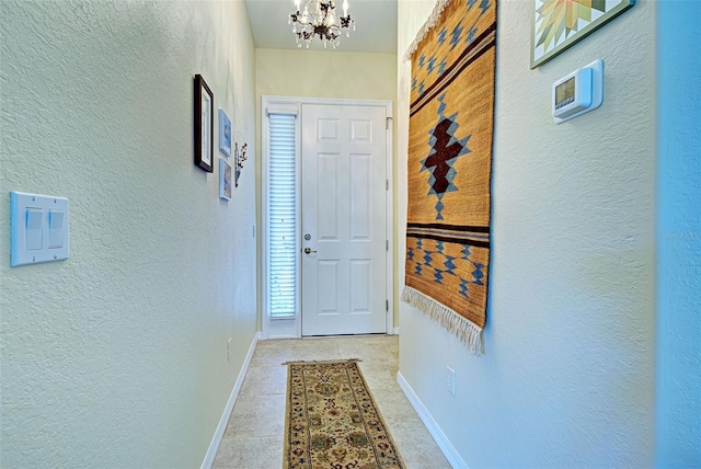 entryway featuring an inviting chandelier and light tile patterned floors