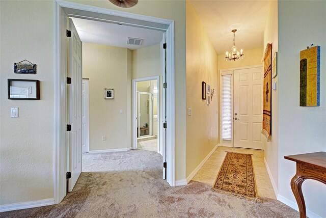 1704 Triano Cir Unit 1704, Venice, FL 34292 - entryway featuring a chandelier, light colored carpet, and baseboards