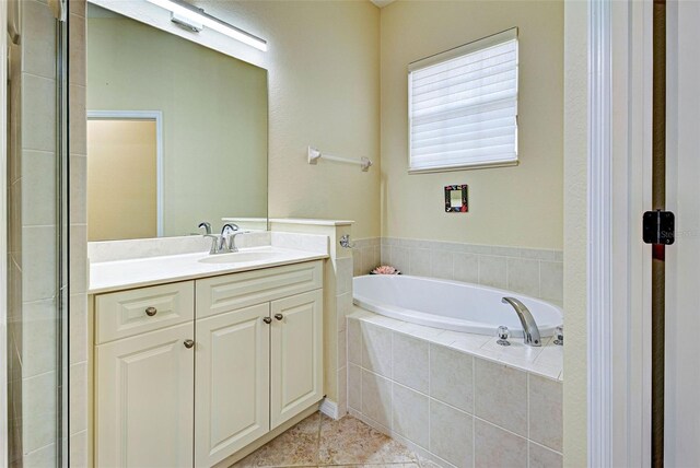 bathroom featuring vanity, independent shower and bath, and tile patterned floors