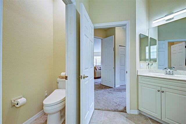 1704 Triano Cir Unit 1704, Venice, FL 34292 - bathroom with toilet, tile patterned flooring, vanity, and baseboards