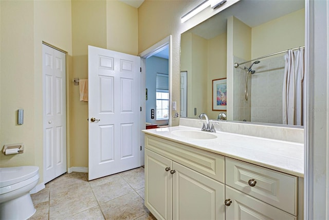 bathroom with toilet, curtained shower, vanity, and tile patterned floors