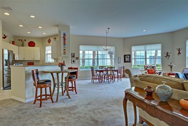 1704 Triano Cir Unit 1704, Venice, FL 34292 - dining room with light carpet, recessed lighting, a chandelier, and baseboards