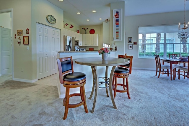 1704 Triano Cir Unit 1704, Venice, FL 34292 - kitchen featuring light carpet, stainless steel appliances, baseboards, white cabinets, and recessed lighting