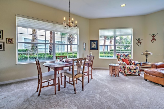 carpeted dining area with a notable chandelier