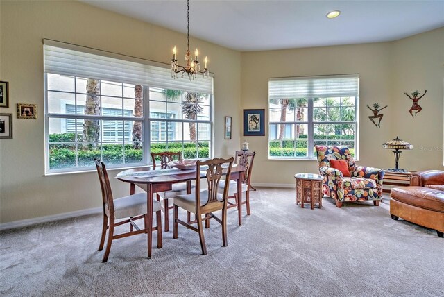 1704 Triano Cir Unit 1704, Venice, FL 34292 - dining room with carpet floors, a chandelier, and baseboards