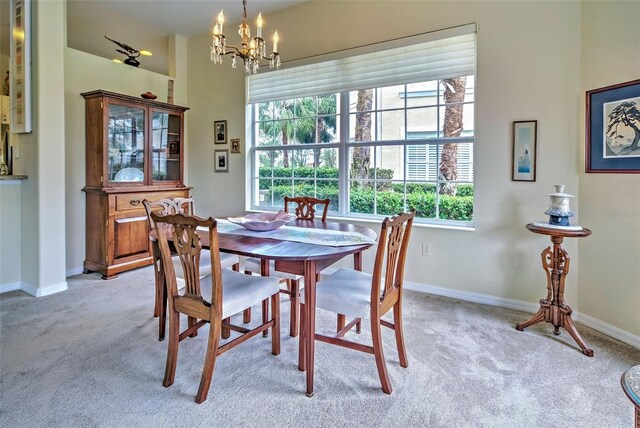 carpeted dining space with a notable chandelier