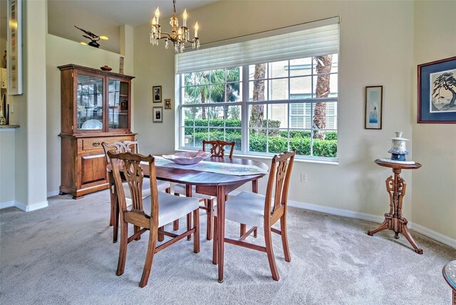 1704 Triano Cir Unit 1704, Venice, FL 34292 - dining area featuring a chandelier, light carpet, and baseboards