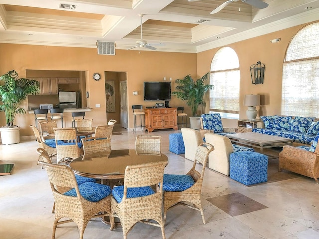 dining area featuring beam ceiling, coffered ceiling, ornamental molding, and ceiling fan