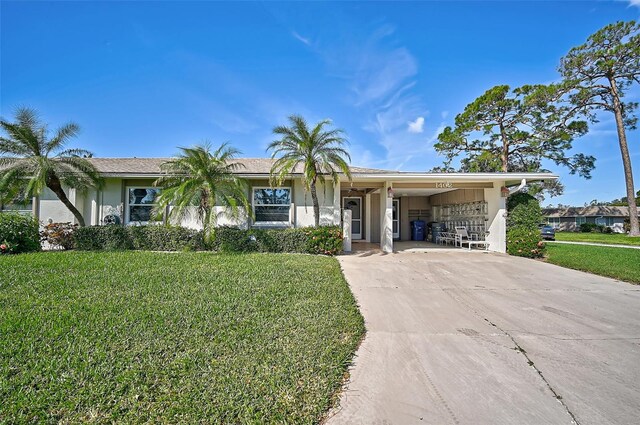 1402 Grand Blvd Unit 240, Sarasota, FL 34232 - ranch-style home with driveway, a front lawn, stucco siding, and a carport