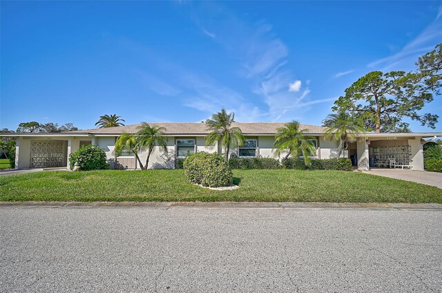 1402 Grand Blvd Unit 240, Sarasota, FL 34232 - ranch-style house with concrete driveway, a front yard, and stucco siding