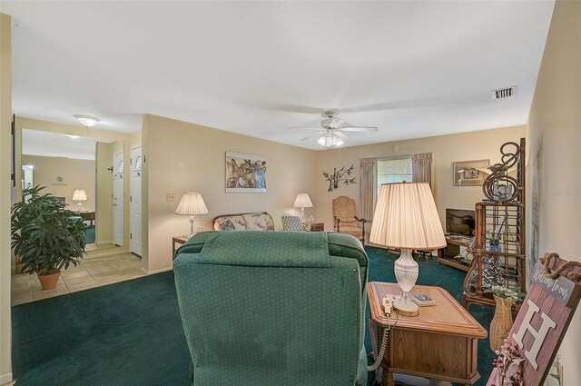 1402 Grand Blvd Unit 240, Sarasota, FL 34232 - living area with a ceiling fan, carpet, tile patterned floors, and baseboards