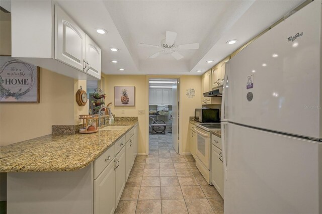 1402 Grand Blvd Unit 240, Sarasota, FL 34232 - kitchen featuring white appliances, a sink, white cabinets, a ceiling fan, and recessed lighting