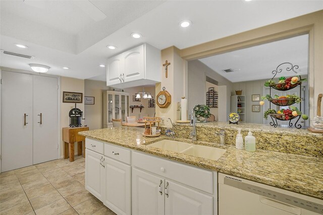 1402 Grand Blvd Unit 240, Sarasota, FL 34232 - kitchen featuring white dishwasher, a sink, light stone counters, recessed lighting, and white cabinets