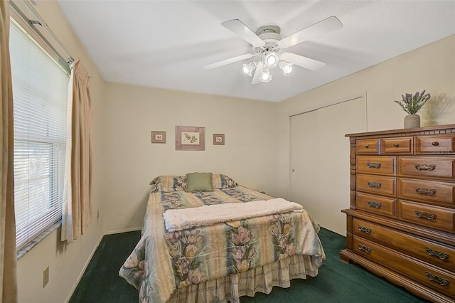 1402 Grand Blvd Unit 240, Sarasota, FL 34232 - bedroom with dark carpet, a closet, and ceiling fan