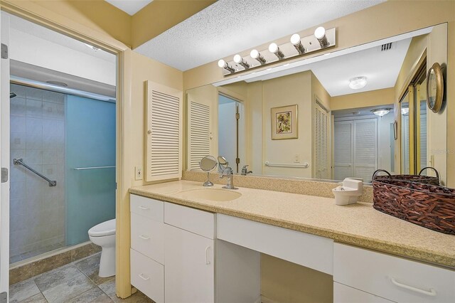 1402 Grand Blvd Unit 240, Sarasota, FL 34232 - full bathroom featuring toilet, a shower stall, vanity, and a closet