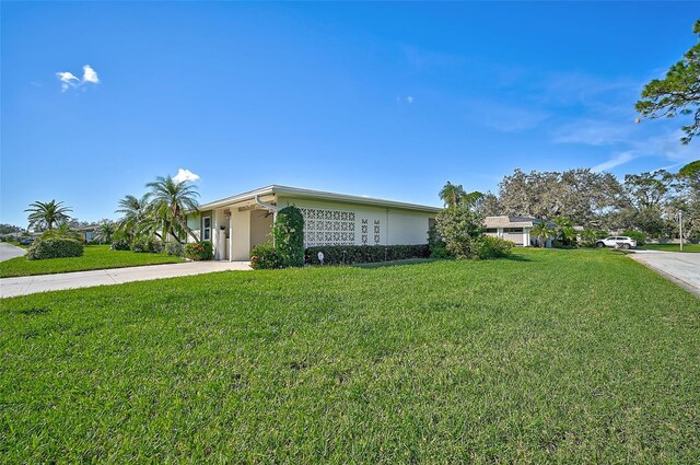 1402 Grand Blvd Unit 240, Sarasota, FL 34232 - view of front of house featuring driveway, a front lawn, and stucco siding
